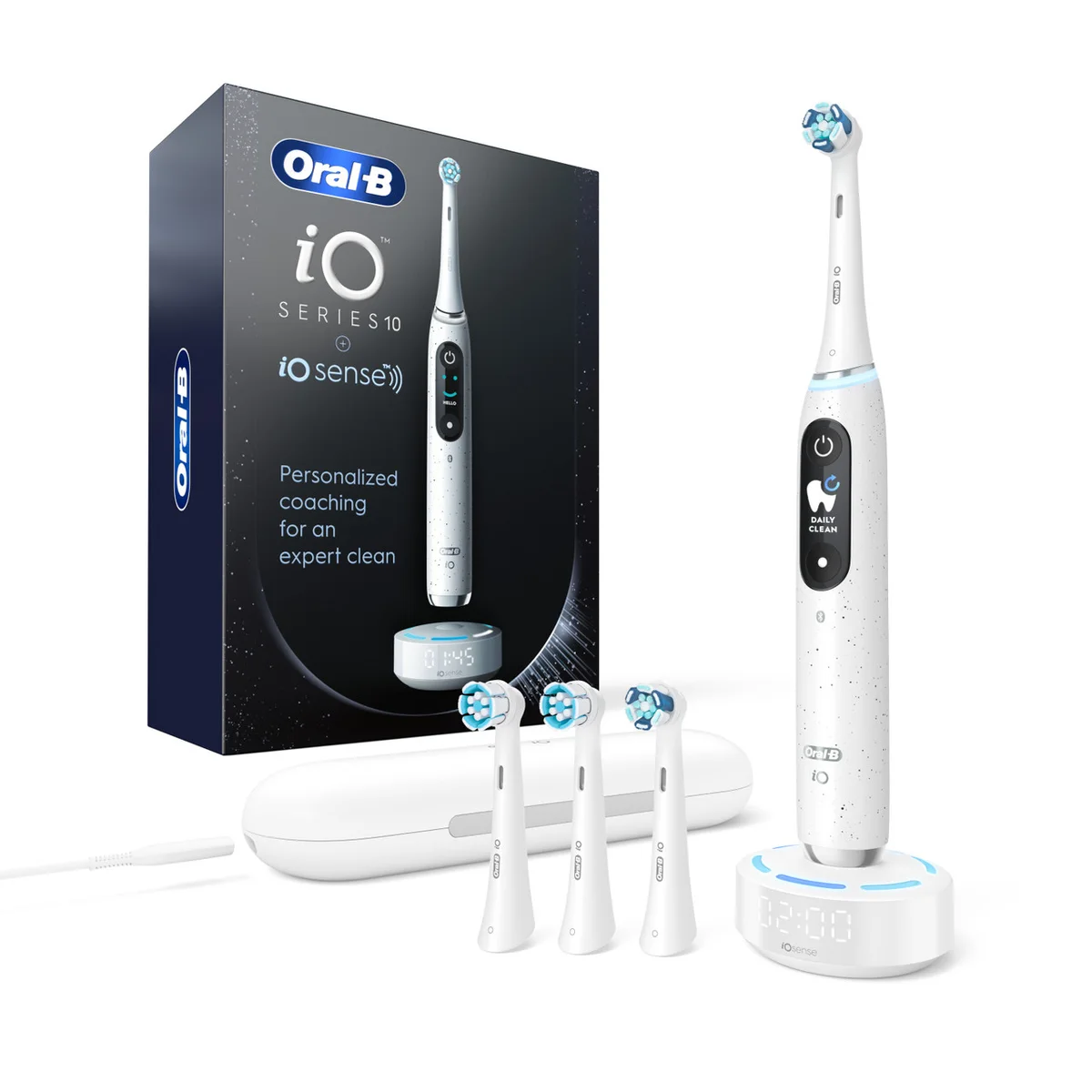 White Oral-B iO Series 10 toothbrush on its smart charger, with three extra brush heads, travel case and retail box.