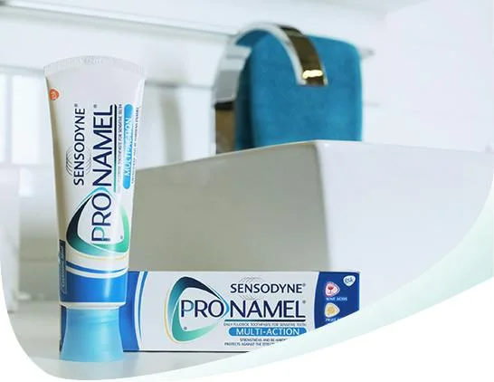Pronamel Multi-Action toothpaste tube and carton beside a white bathroom sink.
