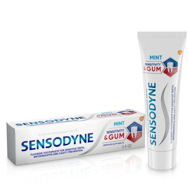A tube of Sensodyne Sensitivity and Gum Mint toothpaste standing beside its retail carton.