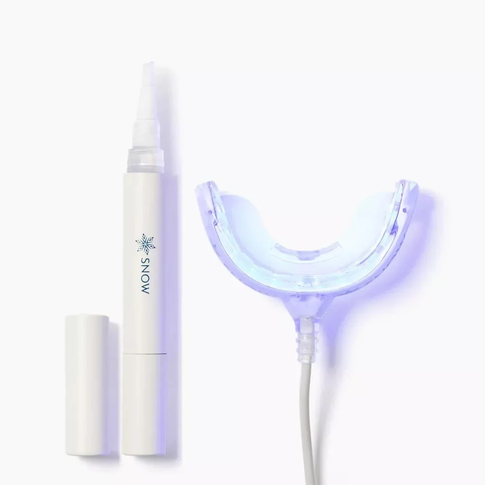 An uncapped SNOW whitening serum pen beside a wired, illuminated whitening mouthpiece on a white background.